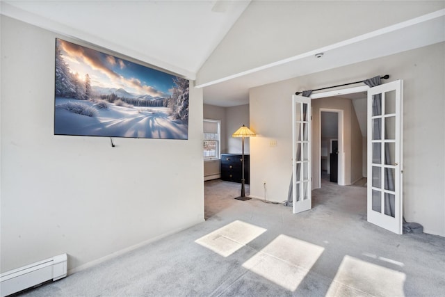 empty room featuring vaulted ceiling, french doors, a baseboard radiator, and light carpet