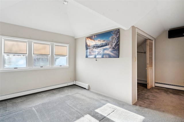 carpeted empty room with baseboard heating and vaulted ceiling