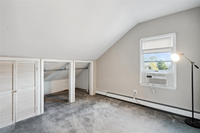 additional living space featuring baseboard heating, light colored carpet, and vaulted ceiling