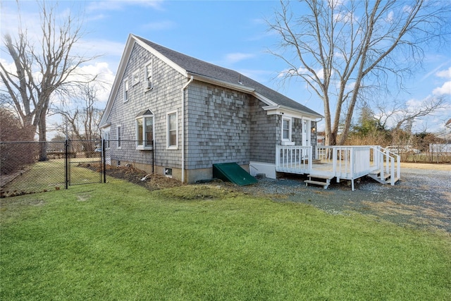 view of side of property featuring a wooden deck and a yard