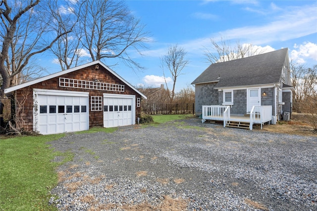 view of front facade featuring a garage and an outdoor structure