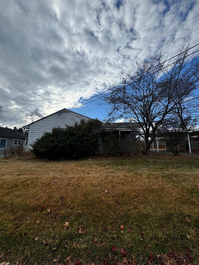 view of side of home with a yard