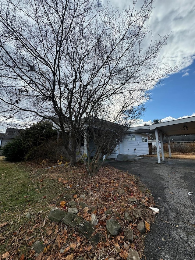 view of side of home with a carport