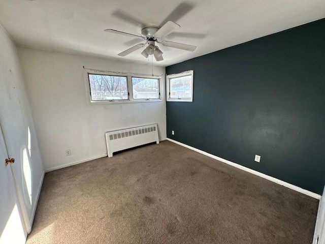 unfurnished room featuring carpet floors, radiator, and ceiling fan