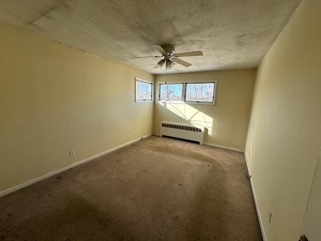 carpeted spare room with radiator heating unit, a textured ceiling, and ceiling fan