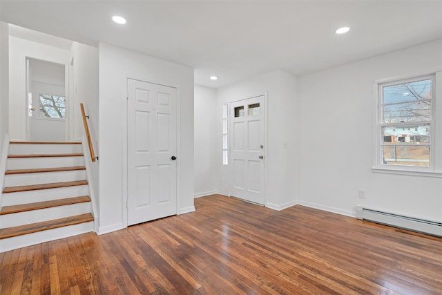 foyer with a baseboard heating unit and dark hardwood / wood-style floors