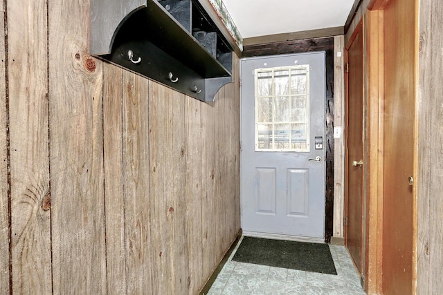 mudroom featuring wood walls