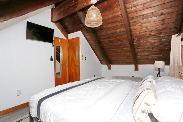 bedroom with lofted ceiling with beams and wood ceiling