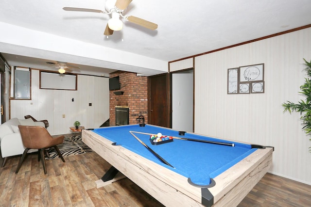 recreation room featuring hardwood / wood-style flooring, electric panel, crown molding, and pool table