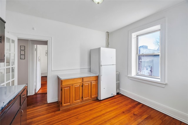 kitchen featuring white fridge and light hardwood / wood-style flooring