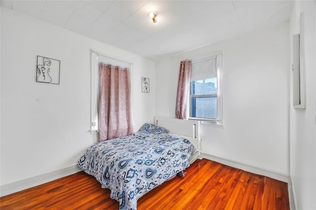 bedroom with hardwood / wood-style floors