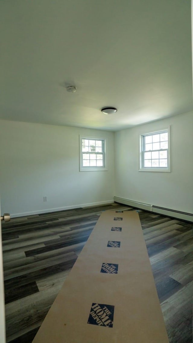 unfurnished room with plenty of natural light and a baseboard radiator