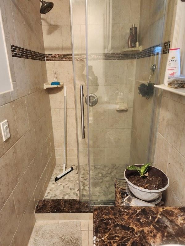 bathroom featuring a shower with shower door