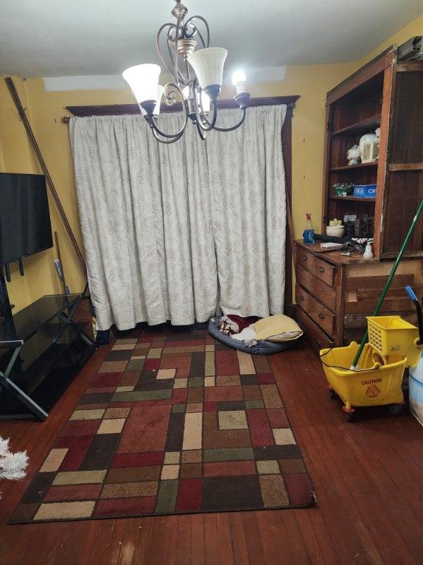 dining room with dark hardwood / wood-style floors and a notable chandelier