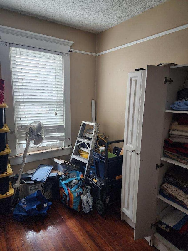 misc room with dark hardwood / wood-style floors and a textured ceiling