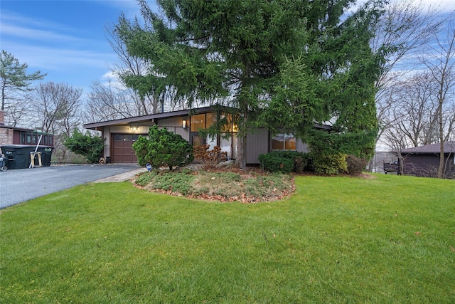 single story home with a garage and a front yard