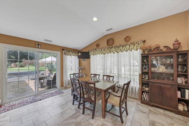 dining space featuring lofted ceiling