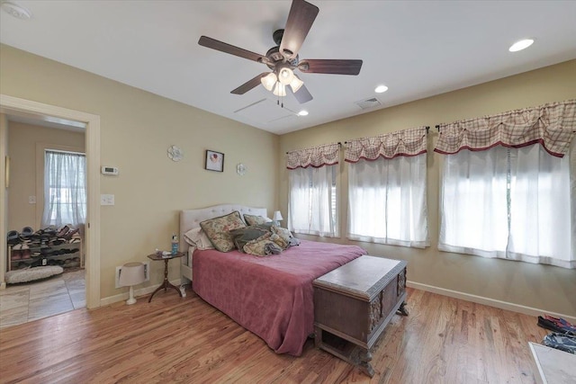 bedroom with ceiling fan and light hardwood / wood-style flooring