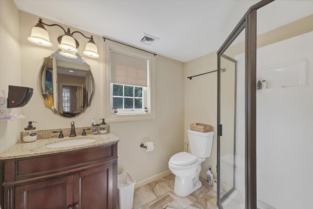 bathroom with vanity, an enclosed shower, and toilet