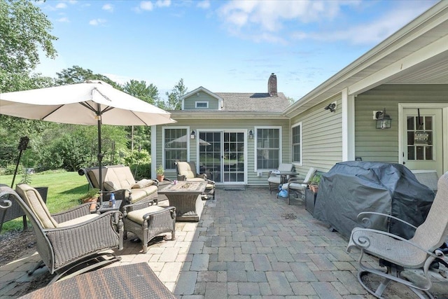 view of patio / terrace featuring an outdoor living space with a fire pit