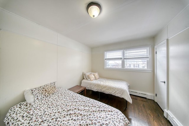 bedroom featuring dark hardwood / wood-style flooring and a baseboard radiator