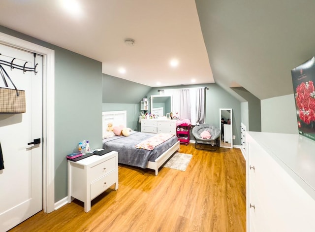 bedroom featuring lofted ceiling and light wood-type flooring