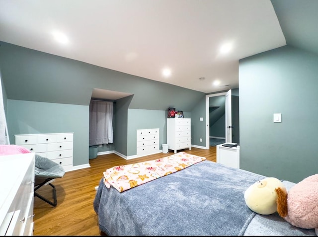 bedroom featuring wood-type flooring and lofted ceiling