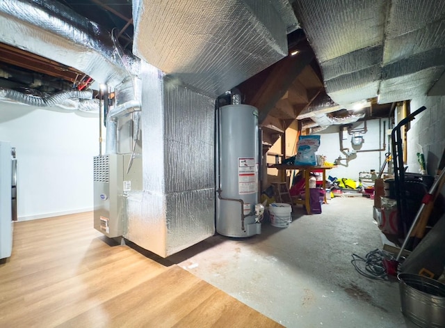 utility room featuring heating unit and gas water heater