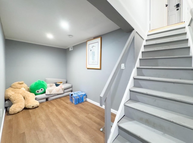 stairway featuring hardwood / wood-style flooring