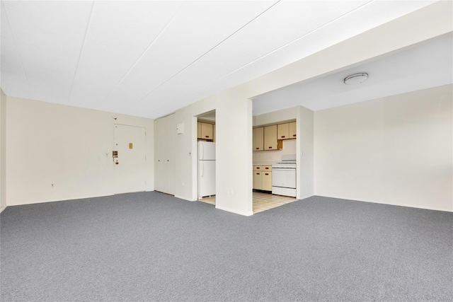 unfurnished living room featuring light colored carpet