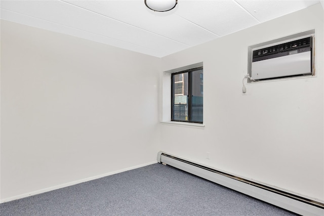 spare room featuring baseboard heating, carpet floors, and an AC wall unit