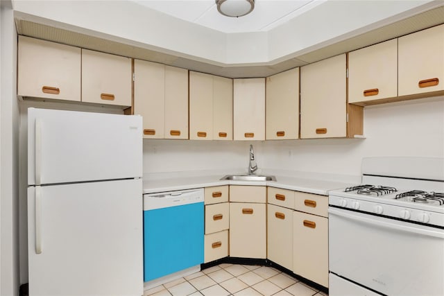 kitchen featuring white appliances, sink, and light tile patterned floors