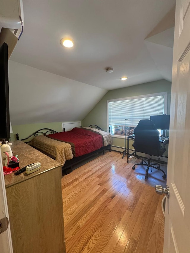 29 Oak St, Islip, NY 11751 - bedroom with light wood-style floors, vaulted ceiling, a desk, baseboard heating, and recessed lighting