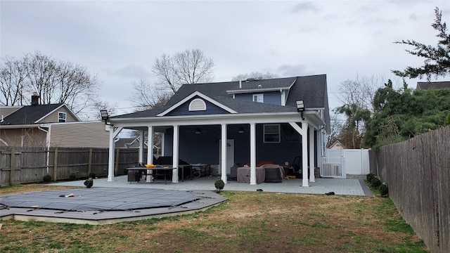 29 Oak St, Islip, NY 11751 - back of property with a patio area, a gate, a fenced backyard, and a shingled roof