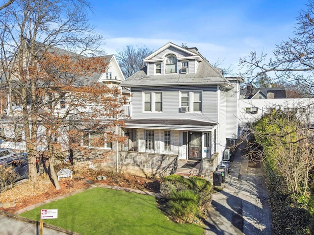 front of property featuring covered porch and a front yard