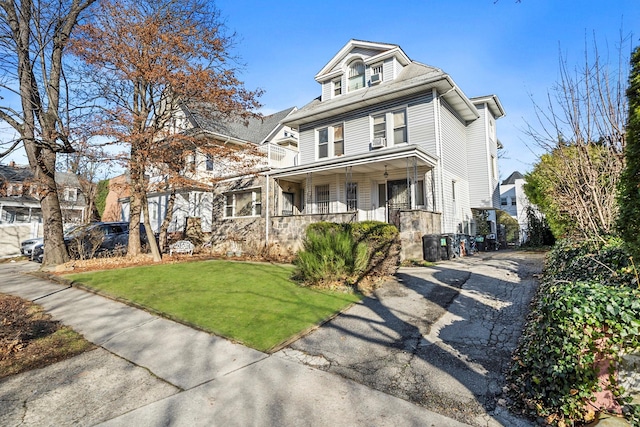 view of front property with a front lawn and covered porch