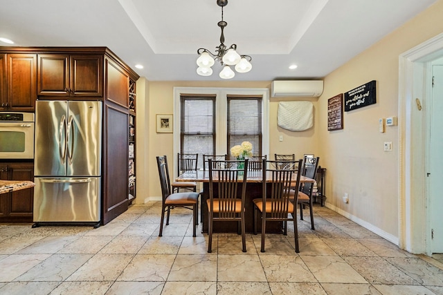 dining area featuring a raised ceiling, a wall mounted air conditioner, and a notable chandelier