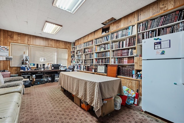 interior space with carpet flooring, built in features, and wooden walls