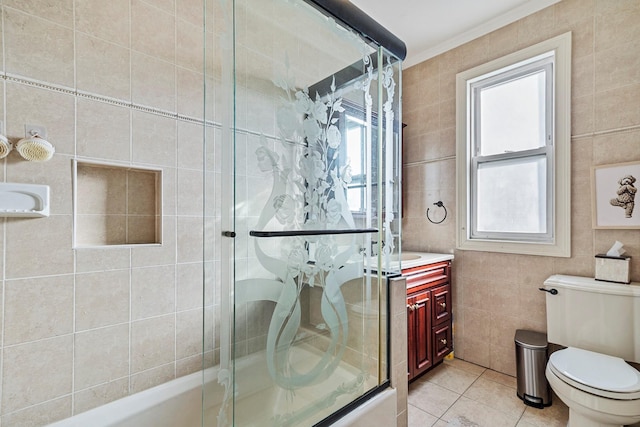 full bathroom with toilet, combined bath / shower with glass door, tile patterned floors, and a healthy amount of sunlight