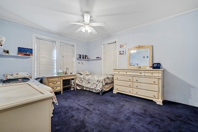 carpeted bedroom featuring ceiling fan and ornamental molding