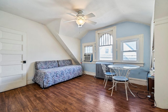 bedroom featuring ceiling fan, dark hardwood / wood-style flooring, radiator heating unit, and vaulted ceiling