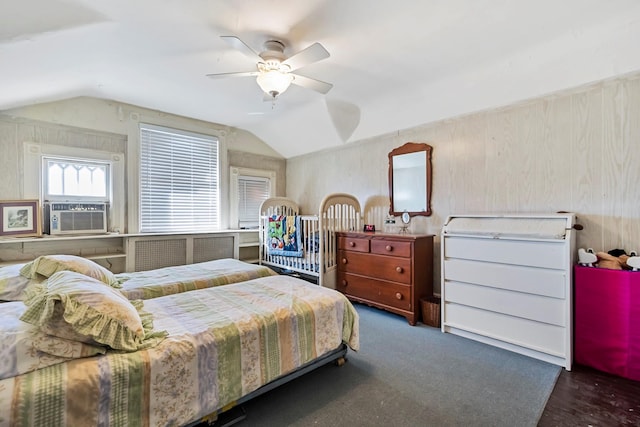 bedroom with ceiling fan, wood walls, cooling unit, and lofted ceiling