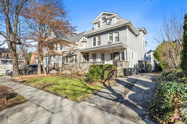 front of property featuring a porch and a front lawn