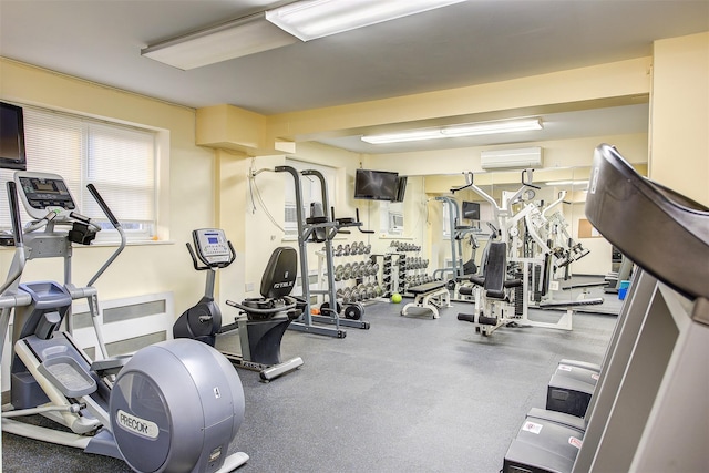 exercise room featuring a wall mounted AC