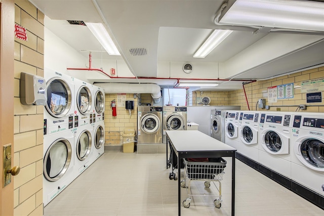 laundry area with washing machine and clothes dryer and stacked washer / dryer