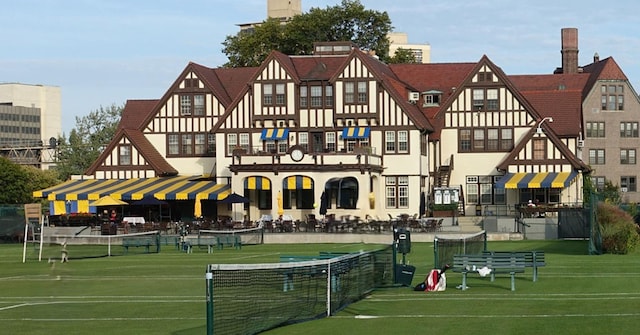 view of sport court with a yard