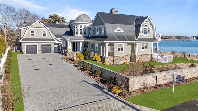 view of front of house with a water view and a garage