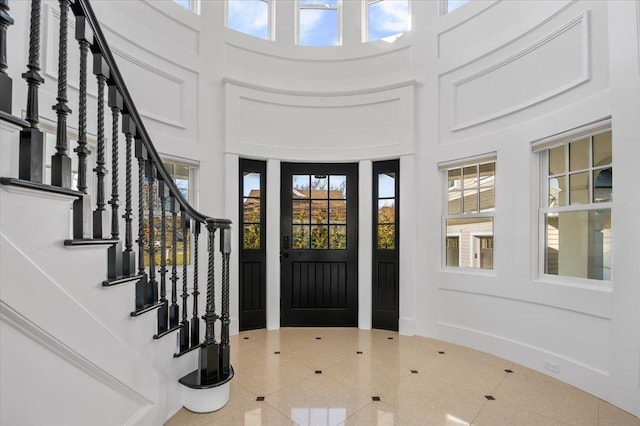 foyer entrance with a high ceiling