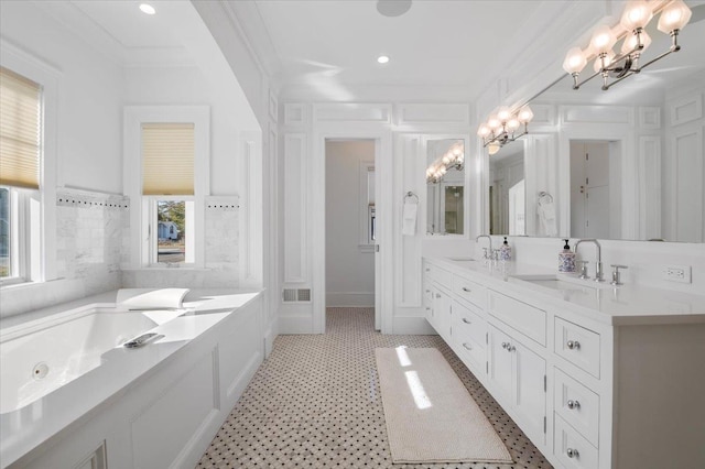 bathroom with vanity, a wealth of natural light, and crown molding