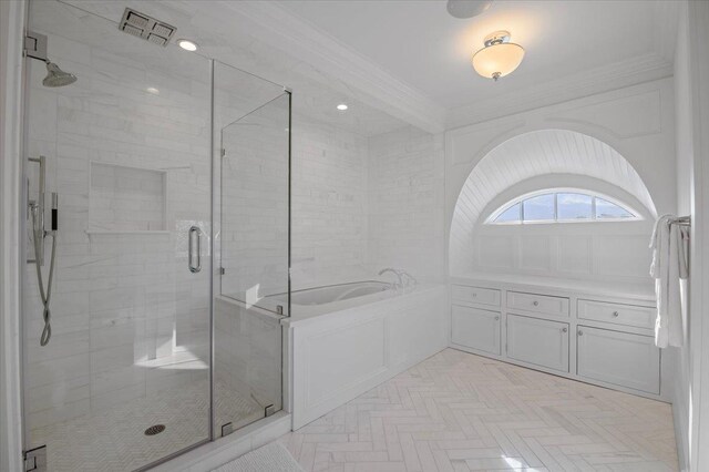 bathroom with a shower with door and crown molding